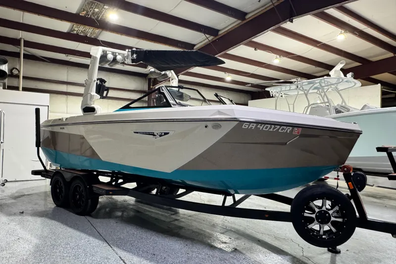  Yacht Photos Pics 2023 Nautique Super Air Nautique S23 boat on trailer in indoor storage.