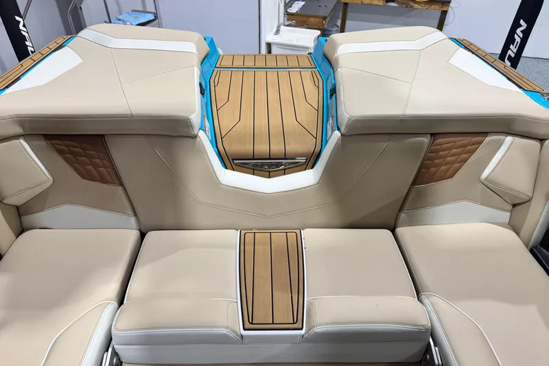  Yacht Photos Pics 2023 Nautique Super Air Nautique S23 interior with beige seating and wood accents.