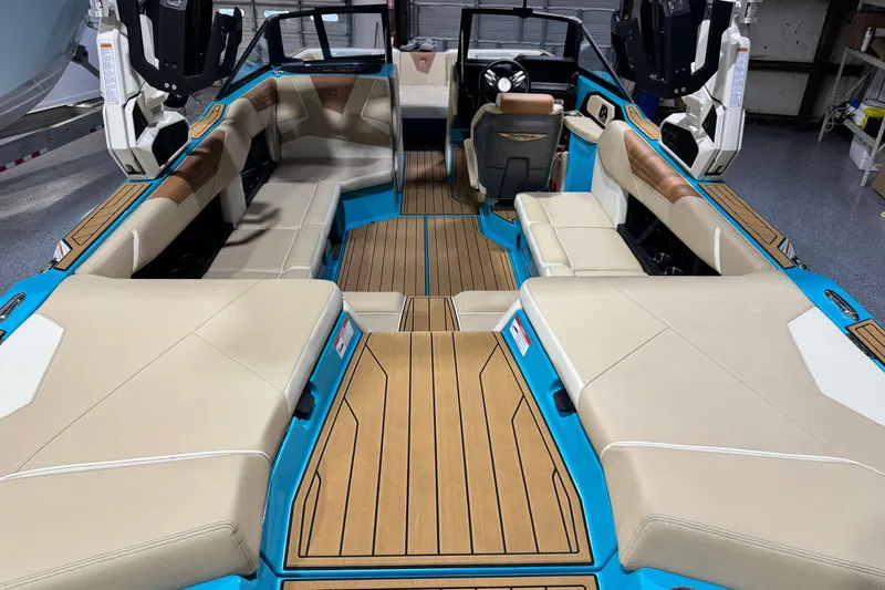  Yacht Photos Pics 2023 Nautique Super Air Nautique S23 interior with beige seating and blue accents.