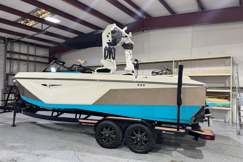  Yacht Photos Pics 2023 Nautique Super Air Nautique S23 boat in a warehouse setting.