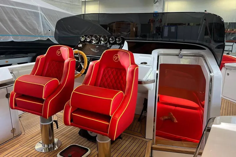 Manda 07 Yacht Photos Pics 2024 Frauscher 1414 Demon Air interior with luxurious red seating and sleek dashboard design.