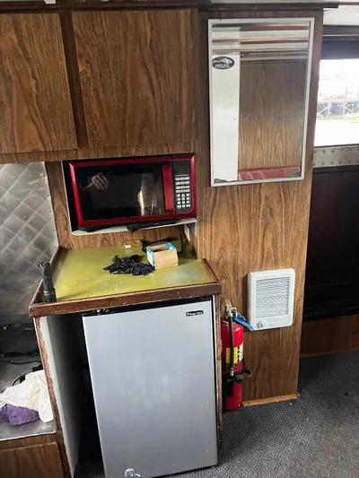 Mi Lana Yacht Photos Pics 1973 Little Hoquiam Fishing Vessel interior with microwave, mini-fridge, and fire extinguisher.