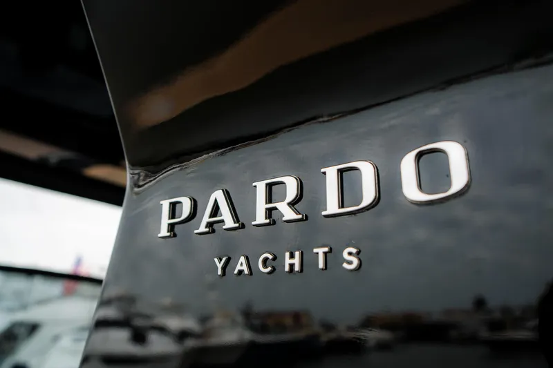  Yacht Photos Pics Close-up of 2024 Pardo Yachts P43 logo on sleek black surface.