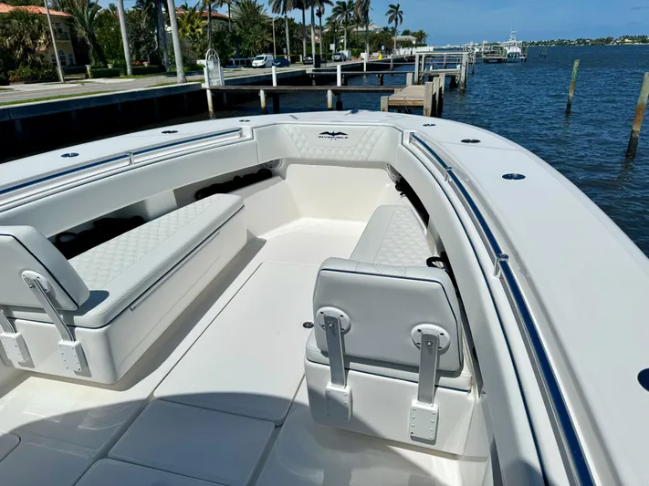  Yacht Photos Pics 2020 Invincible 36' Open Fisherman boat interior with white seating and waterfront view.