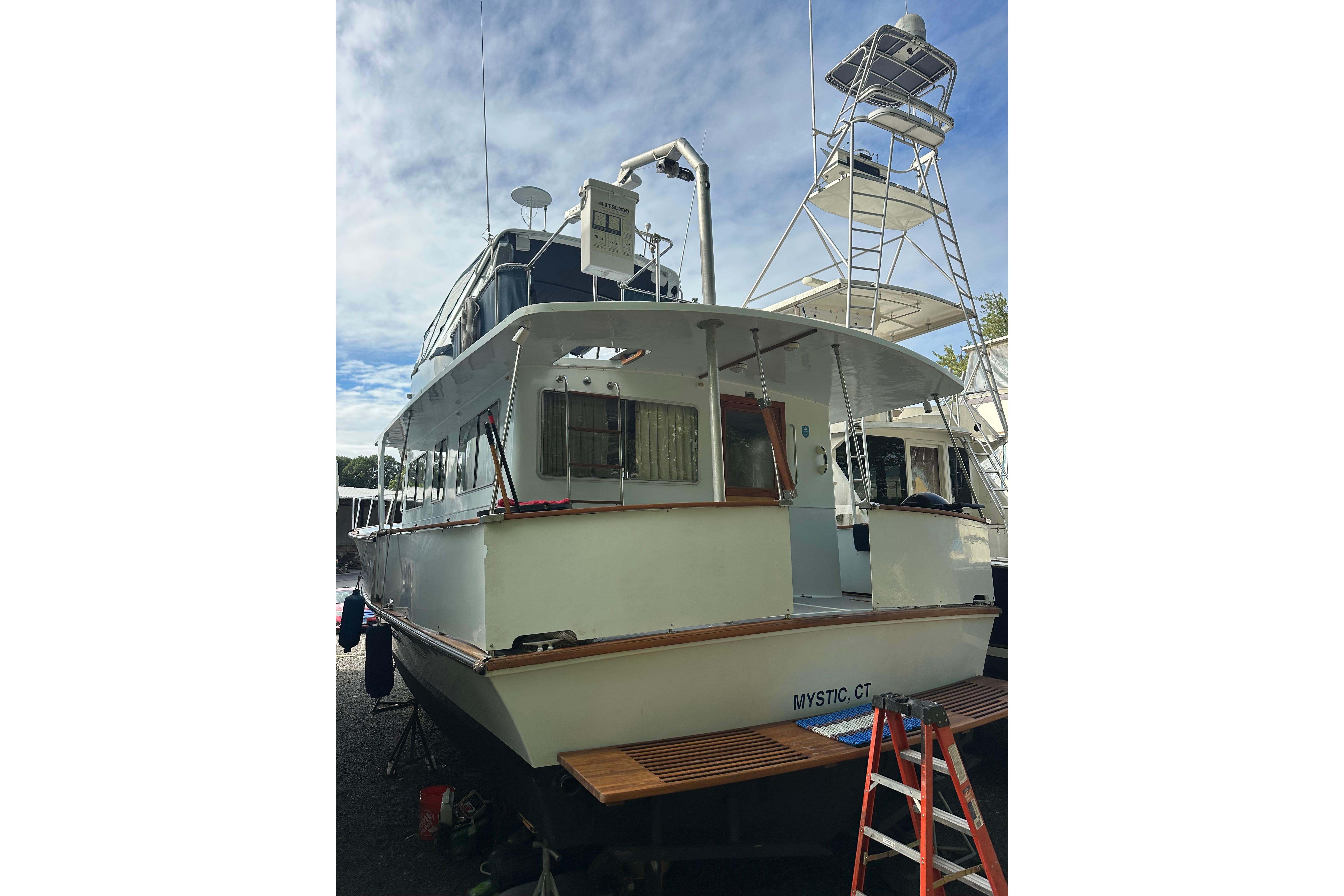 1985 Pearson 43 Trawler docked, featuring a spacious deck and tower, located in Mystic, CT.