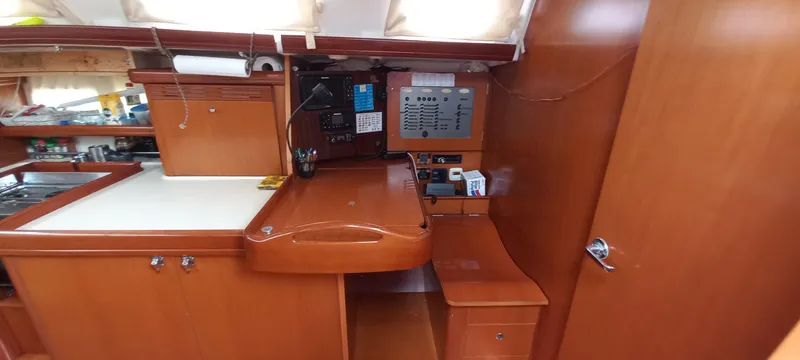 Kaskara Yacht Photos Pics Interior of 2007 Beneteau Oceanis Clipper 523 yacht, featuring navigation station and wooden cabinetry.