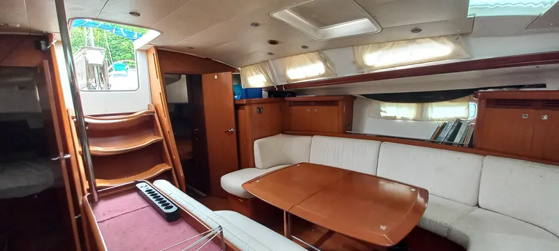 Kaskara Yacht Photos Pics Interior of 2007 Beneteau Oceanis Clipper 523 yacht with wooden furnishings and white seating.
