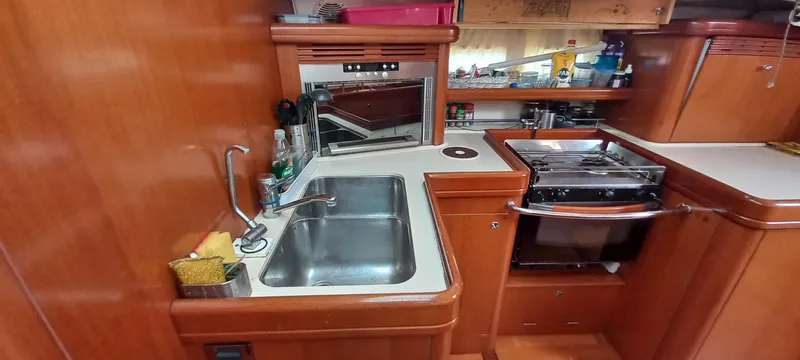 Kaskara Yacht Photos Pics Galley kitchen in 2007 Beneteau Oceanis Clipper 523 yacht with sink and stove.
