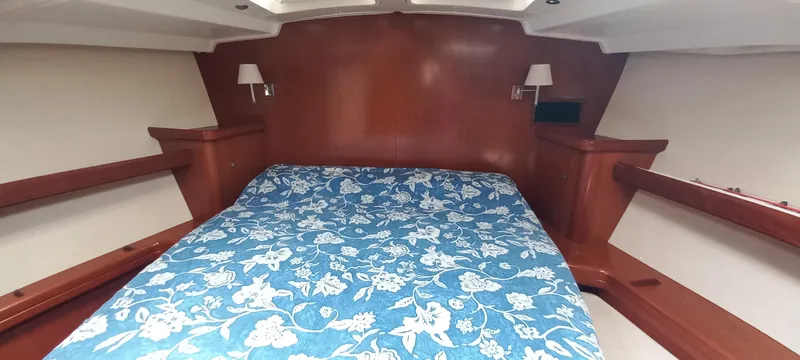 Kaskara Yacht Photos Pics Interior cabin of 2007 Beneteau Oceanis Clipper 523 with floral bedspread.