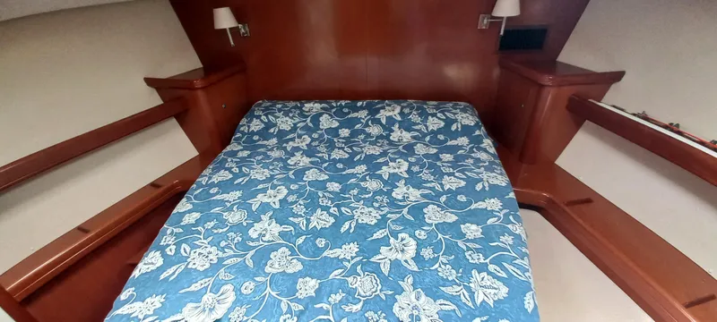 Kaskara Yacht Photos Pics 2007 Beneteau Oceanis Clipper 523 cabin with floral bedspread and wooden interior.