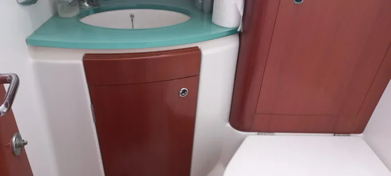 Kaskara Yacht Photos Pics 2007 Beneteau Oceanis Clipper 523 bathroom with wooden cabinetry and modern sink.