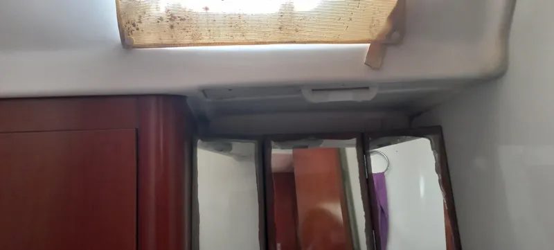 Kaskara Yacht Photos Pics Interior of 2007 Beneteau Oceanis Clipper 523 with mirrors and wooden cabinetry.