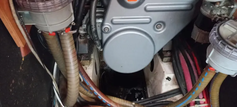 Kaskara Yacht Photos Pics Engine compartment of a 2007 Beneteau Oceanis Clipper 523 sailboat, showing hoses and components.