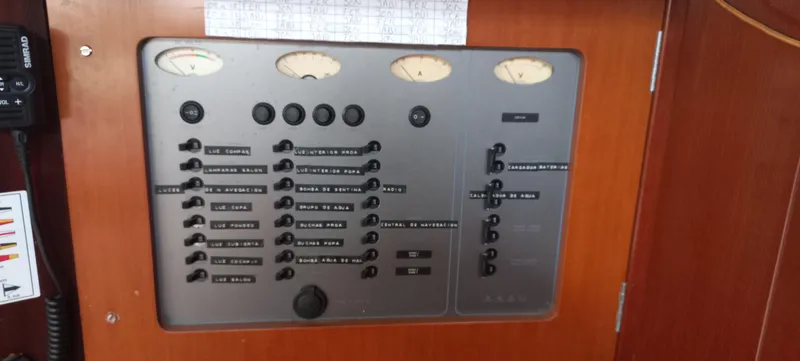 Kaskara Yacht Photos Pics Control panel of a 2007 Beneteau Oceanis Clipper 523 yacht with labeled switches and gauges.