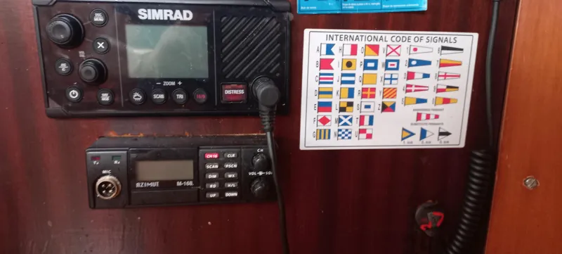 Kaskara Yacht Photos Pics Control panel on a 2007 Beneteau Oceanis Clipper 523 with communication devices and signal chart.