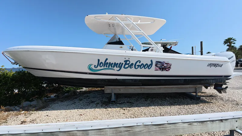 Johnny Be Good Yacht Photos Pics 2012 Intrepid 327 CC boat named "Johnny Be Good" on a gravel surface.