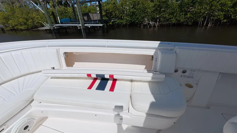 Johnny Be Good Yacht Photos Pics 2012 Intrepid 327 CC boat interior with white seating and striped cushion.