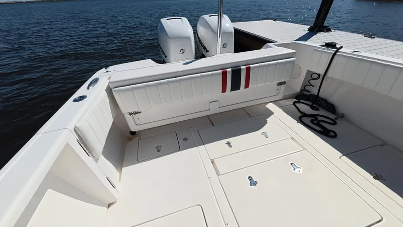 Johnny Be Good Yacht Photos Pics 2012 Intrepid 327 CC boat deck with twin engines, spacious seating, and storage compartments.