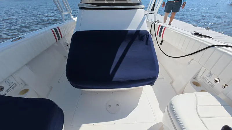 Johnny Be Good Yacht Photos Pics 2012 Intrepid 327 CC boat interior with blue and white seating, docked by the water.