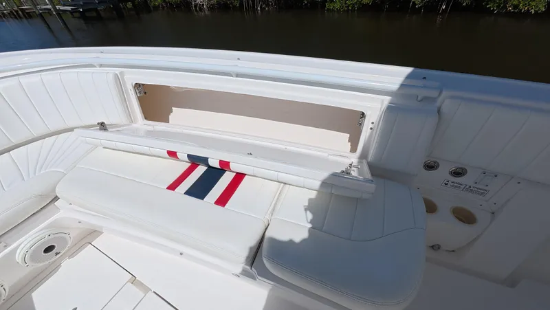 Johnny Be Good Yacht Photos Pics 2012 Intrepid 327 CC boat interior with white seating and storage compartment.