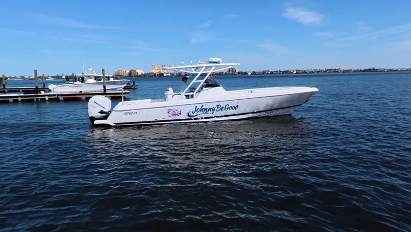 Johnny Be Good Yacht Photos Pics 2012 Intrepid 327 CC boat named "Johnny Be Good" on calm water.