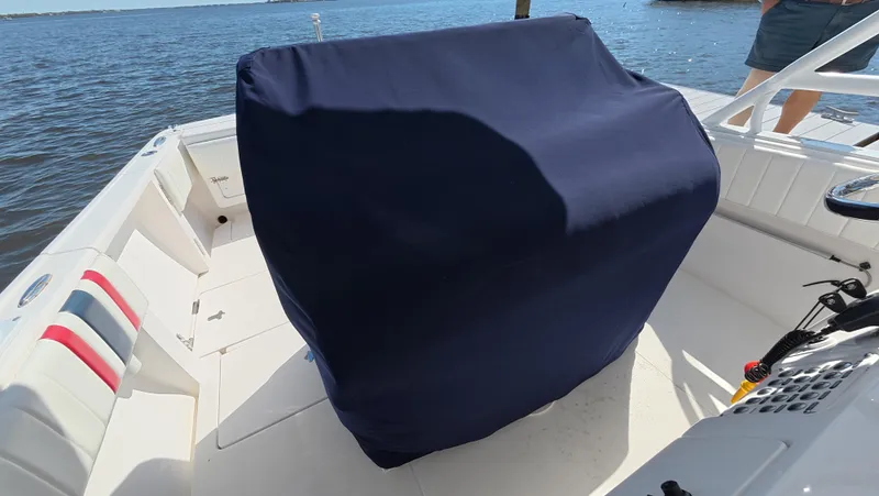 Johnny Be Good Yacht Photos Pics 2012 Intrepid 327 CC boat interior with covered seating, near water.