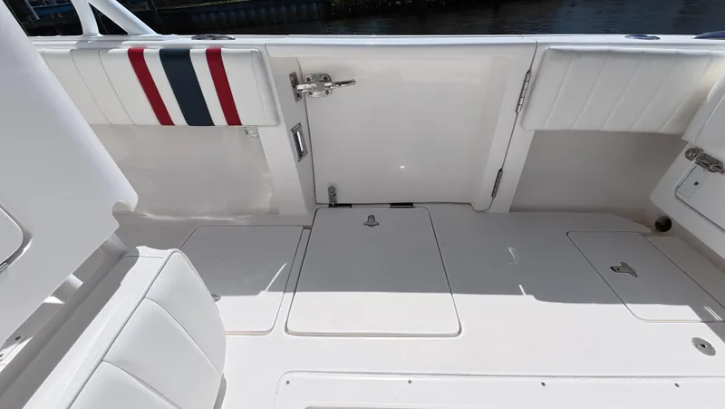 Johnny Be Good Yacht Photos Pics 2012 Intrepid 327 CC boat interior with white seating and storage compartments.