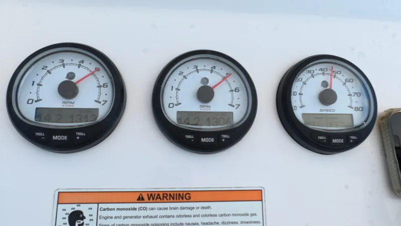 Johnny Be Good Yacht Photos Pics Close-up of 2012 Intrepid 327 CC boat gauges and warning label.