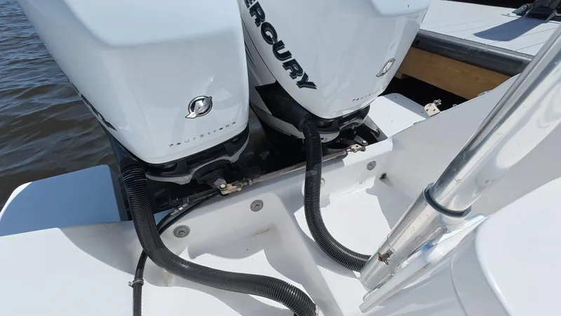 Johnny Be Good Yacht Photos Pics Twin Mercury outboard engines on a 2012 Intrepid 327 CC boat, docked by the water.