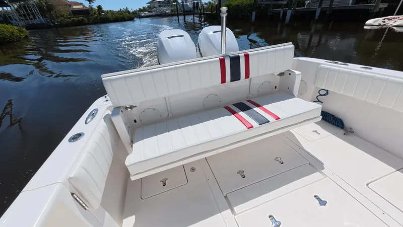 Johnny Be Good Yacht Photos Pics 2012 Intrepid 327 CC boat with white seating and dual engines on a calm waterway.