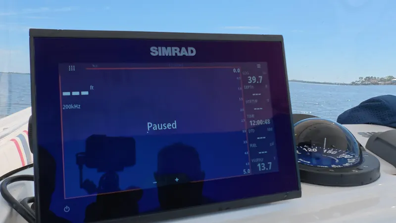 Johnny Be Good Yacht Photos Pics Simrad display on 2012 Intrepid 327 CC boat, showing paused navigation data.