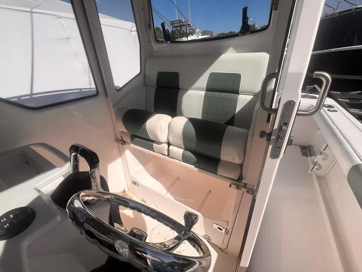  Yacht Photos Pics Interior of 2015 Everglades 295 Pilot boat with steering wheel and cushioned seat.