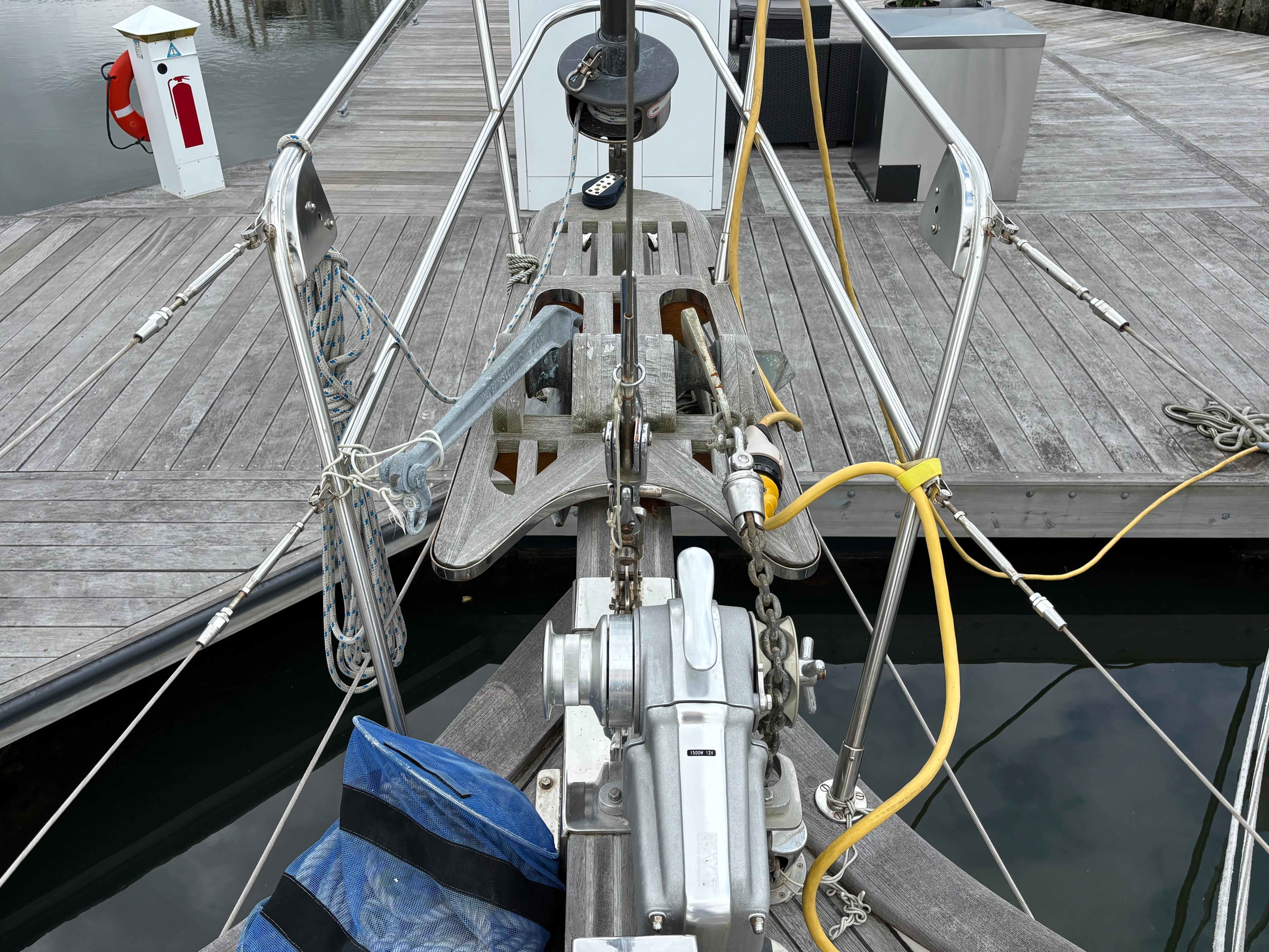Bow of 1987 Ta Shing Tashiba 36 sailboat docked, showing anchor and deck equipment.