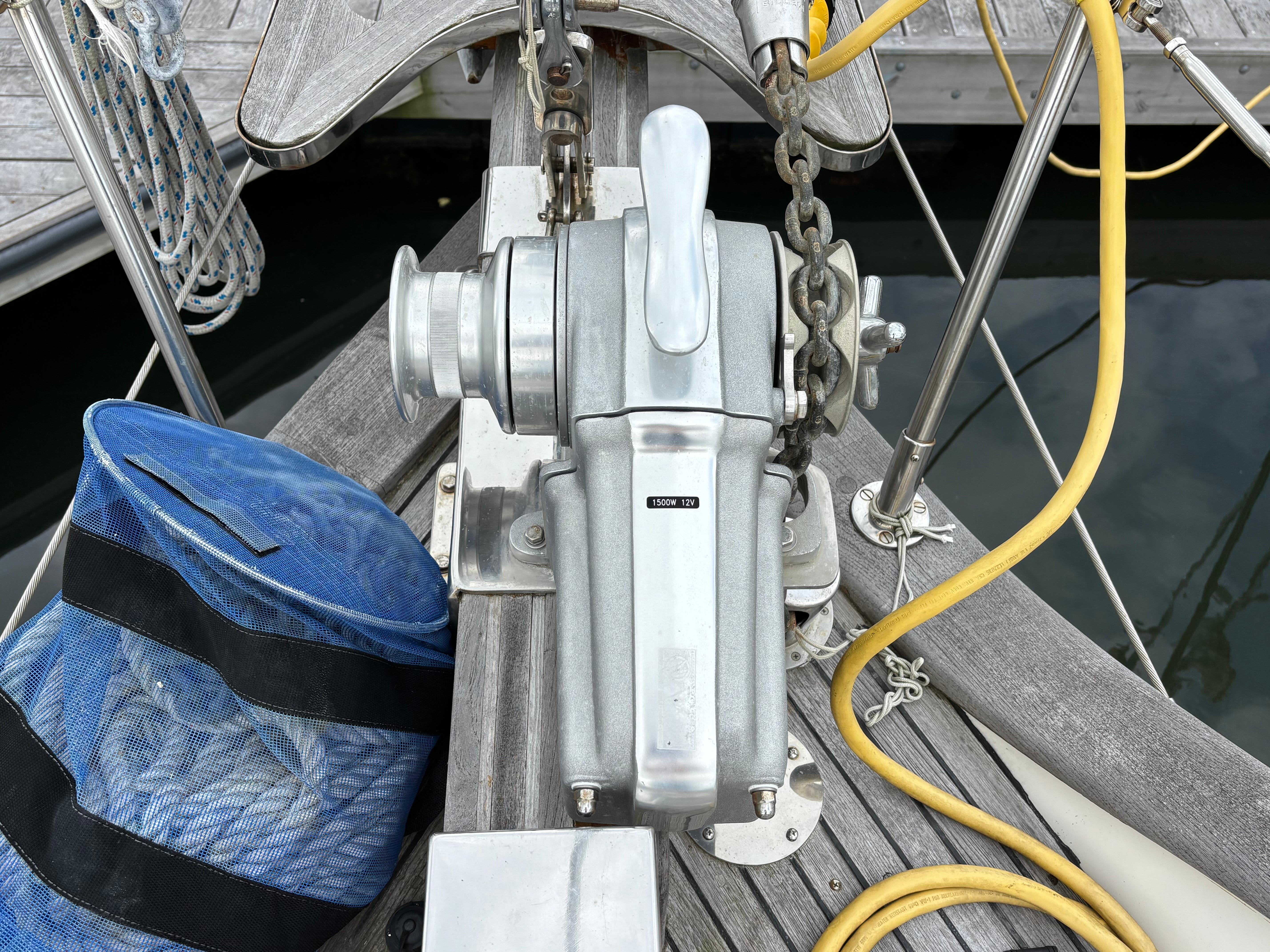 Anchor windlass on 1987 Ta Shing Tashiba 36 sailboat deck with blue rope bag.