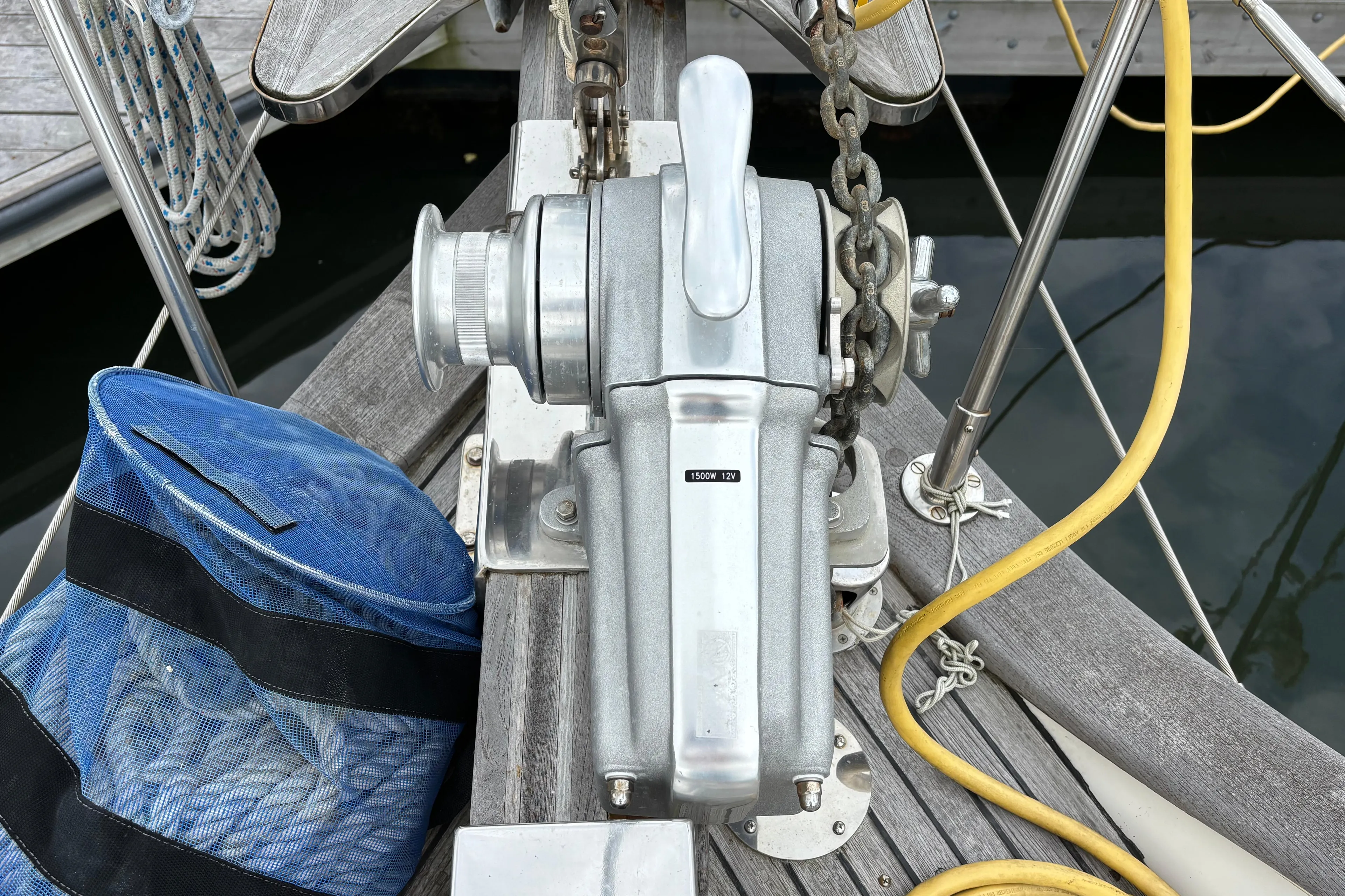 Anchor windlass on 1987 Ta Shing Tashiba 36 sailboat deck with blue rope bag.