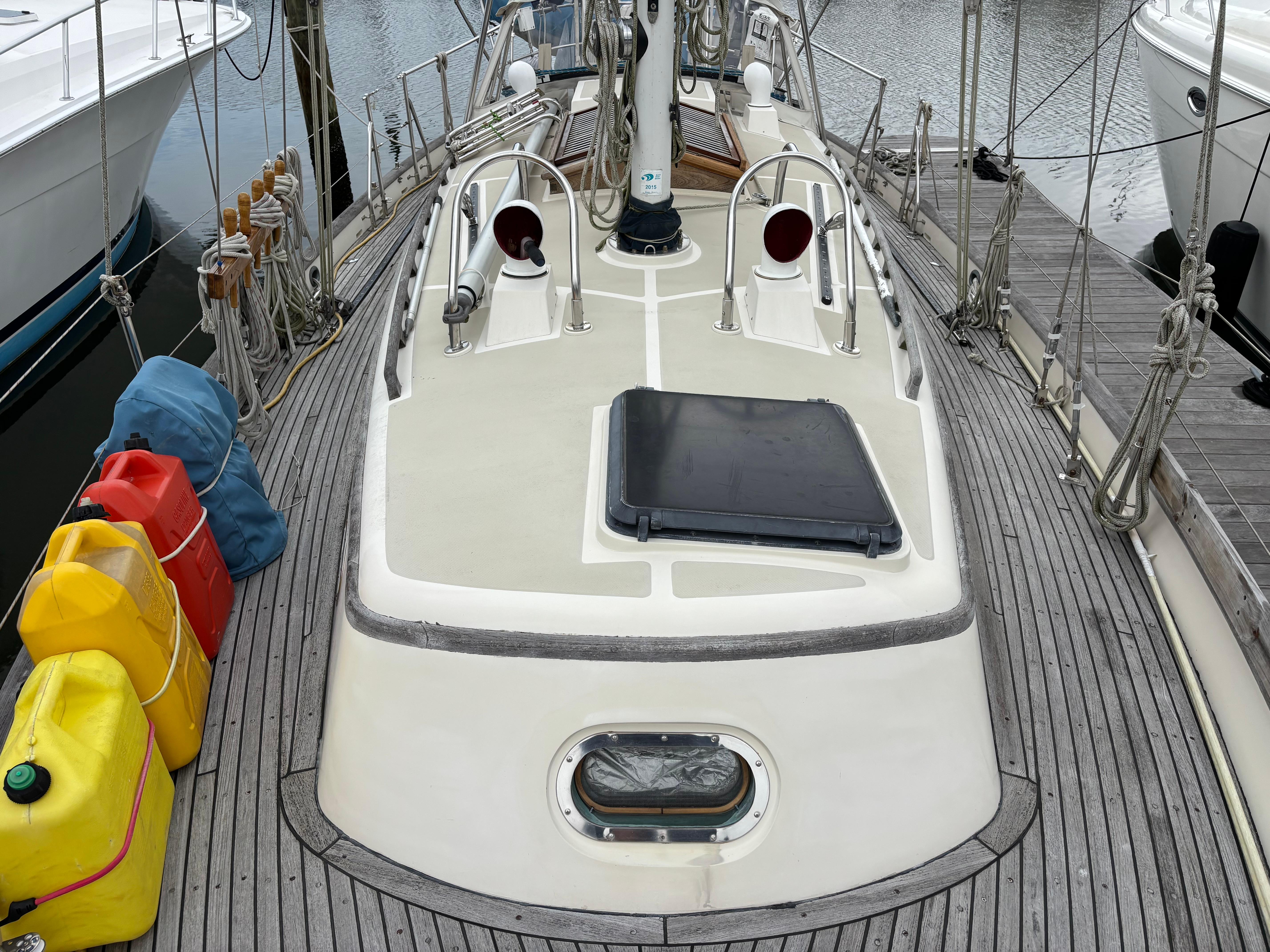 1987 Ta Shing Tashiba 36 sailboat deck with fuel containers and ropes at dock.