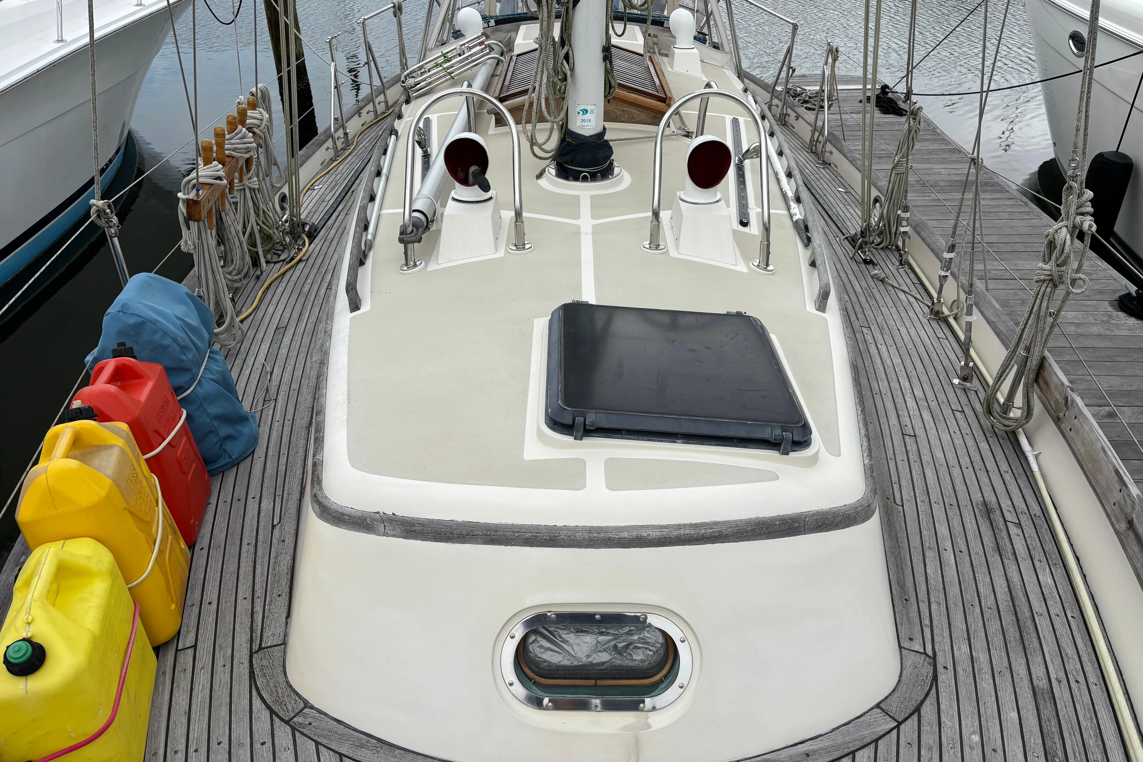 1987 Ta Shing Tashiba 36 sailboat deck with fuel containers and ropes at dock.