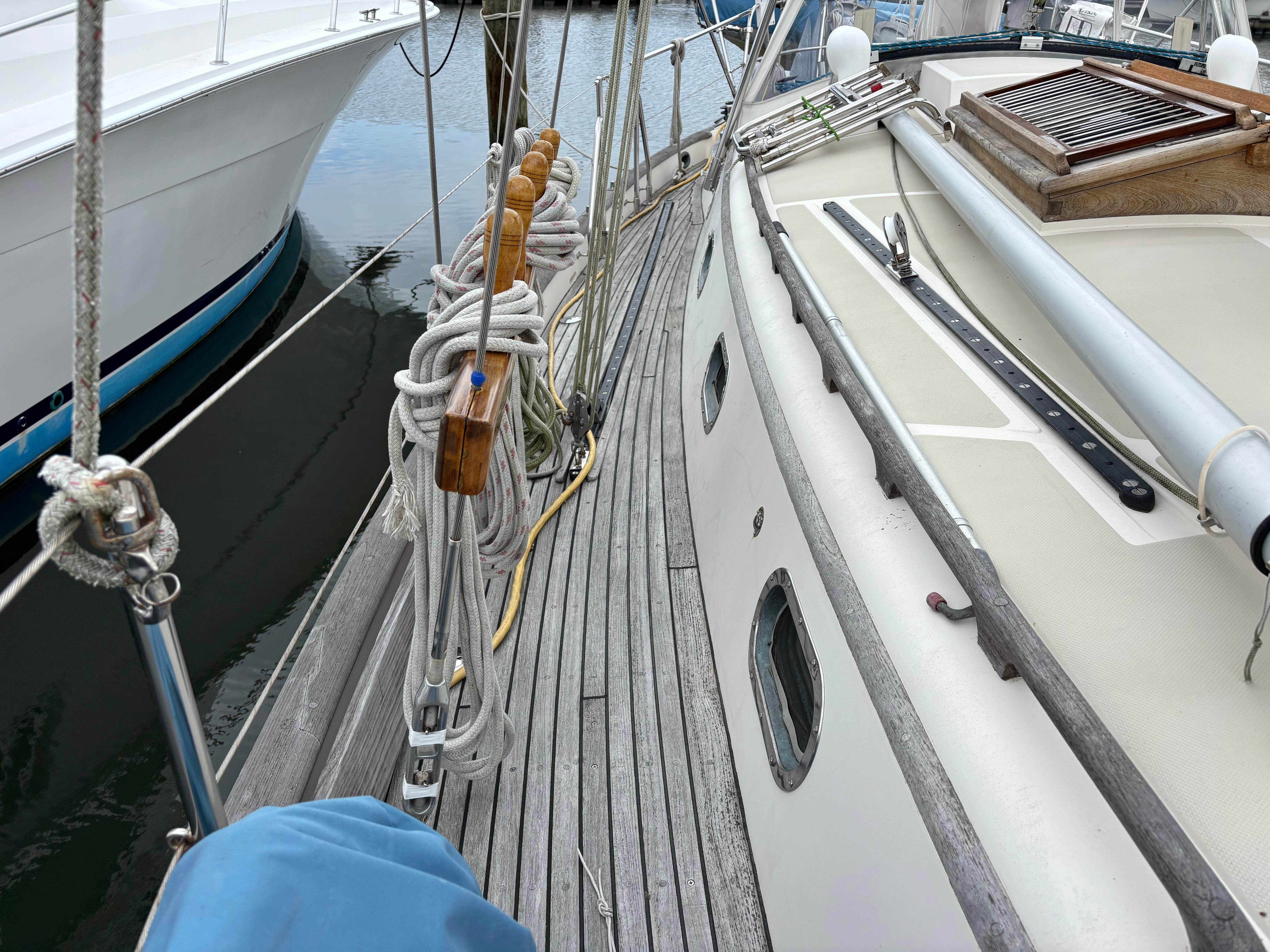 1987 Ta Shing Tashiba 36 sailboat deck with ropes and wooden details at a marina.