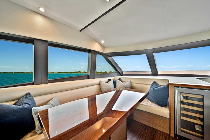 West Yacht Photos Pics Interior of 2017 Hatteras 60 Motor Yacht with panoramic windows and plush seating.