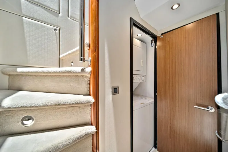 West Yacht Photos Pics Interior of 2017 Hatteras 60 Motor Yacht with stairs and laundry area.