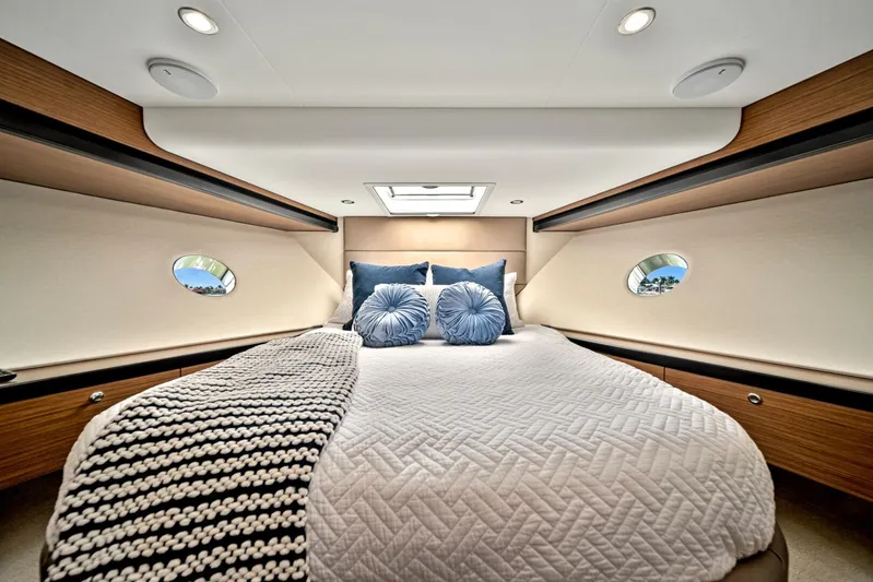 West Yacht Photos Pics Luxurious bedroom in 2017 Hatteras 60 Motor Yacht with modern decor and skylight.