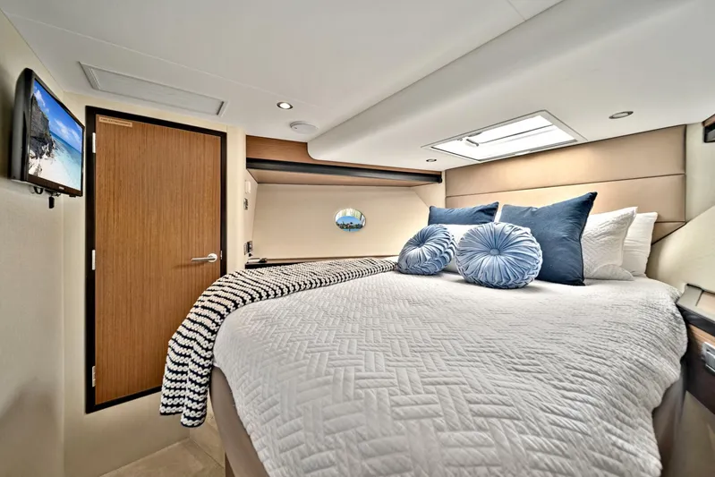 West Yacht Photos Pics Luxurious bedroom in 2017 Hatteras 60 Motor Yacht with cozy bedding and modern decor.