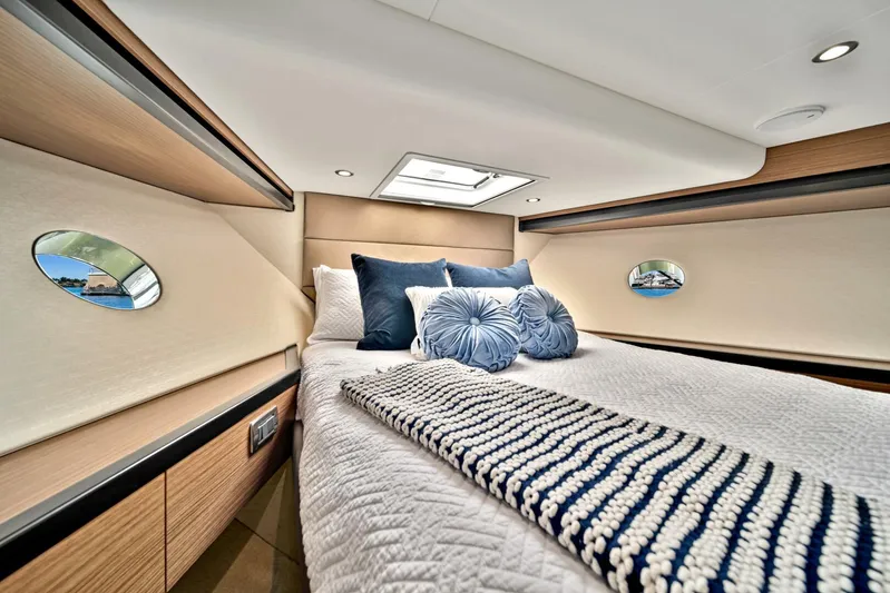 West Yacht Photos Pics Luxurious bedroom interior of 2017 Hatteras 60 Motor Yacht with plush bedding and modern design.