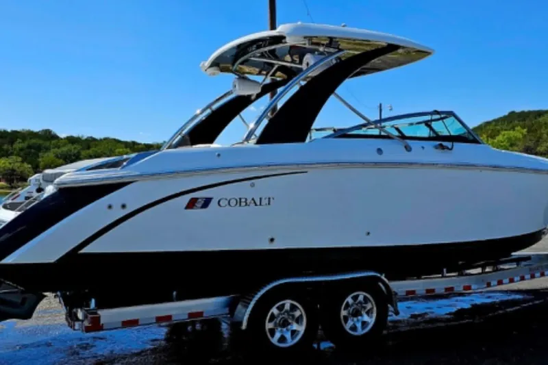  Yacht Photos Pics 2023 Cobalt R30 boat on trailer, sleek design, parked outdoors.