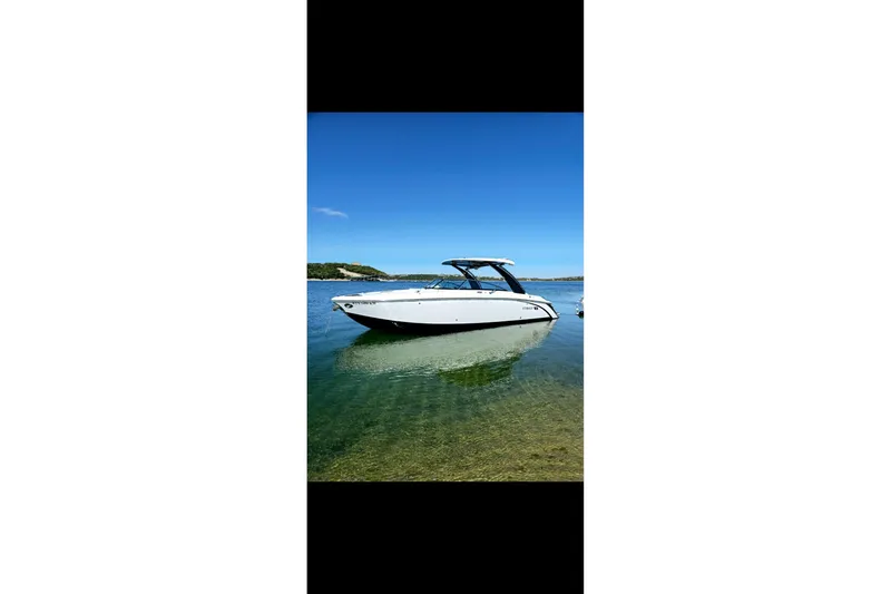  Yacht Photos Pics 2023 Cobalt R30 boat on clear water under blue sky.