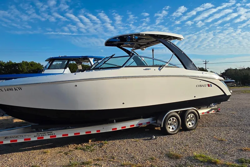  Yacht Photos Pics 2023 Cobalt R30 boat on trailer under blue sky.