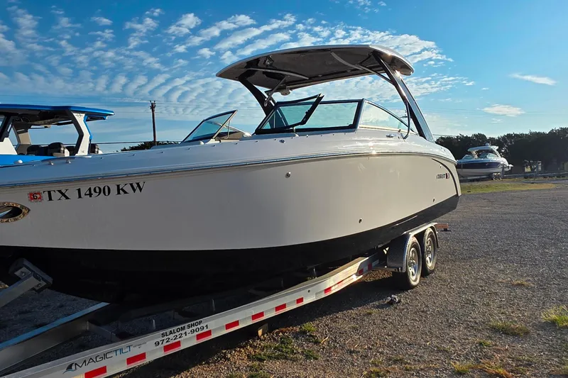  Yacht Photos Pics 2023 Cobalt R30 boat on trailer under clear blue sky.