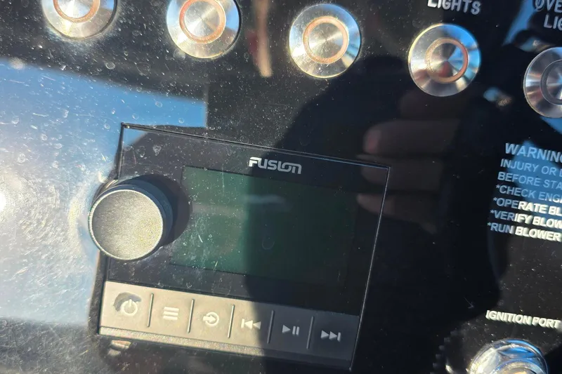  Yacht Photos Pics 2023 Cobalt R30 boat dashboard with Fusion audio system and control buttons.
