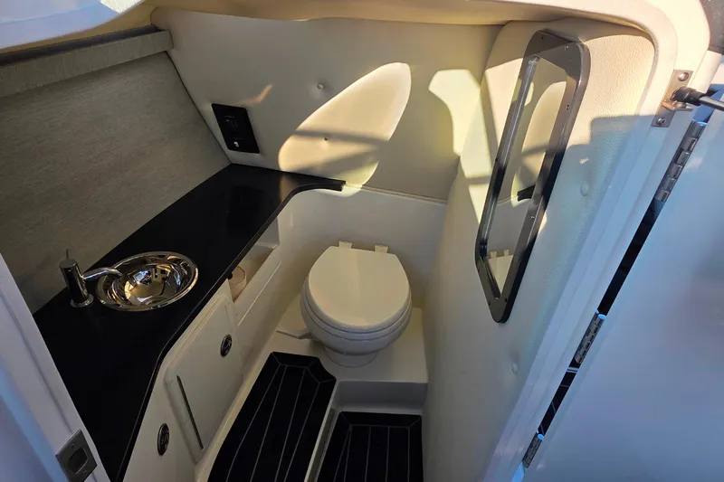  Yacht Photos Pics 2023 Cobalt R30 boat interior bathroom with sink, toilet, and mirror.