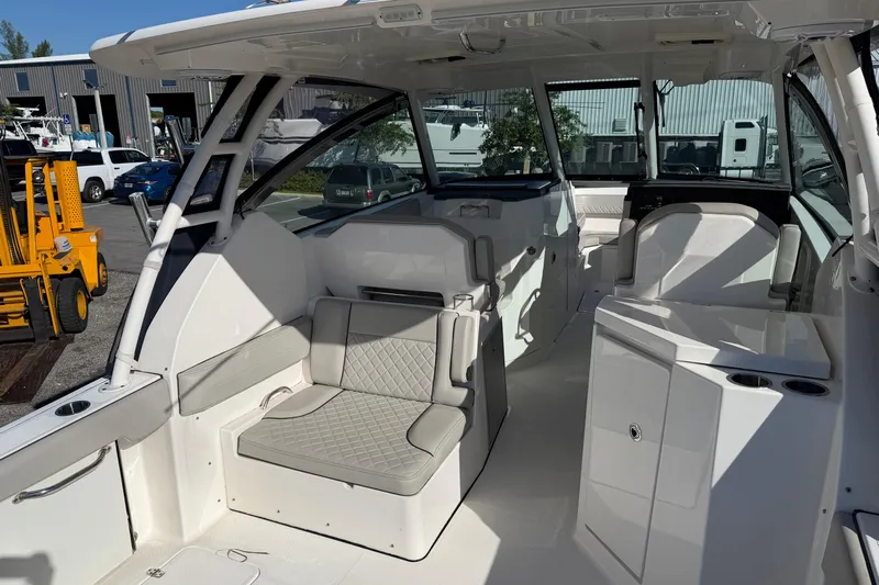  Yacht Photos Pics 2023 Pursuit DC 295 Dual Console boat interior with seating and storage compartments.